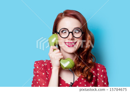girl in red dress with green dial phone 15784675