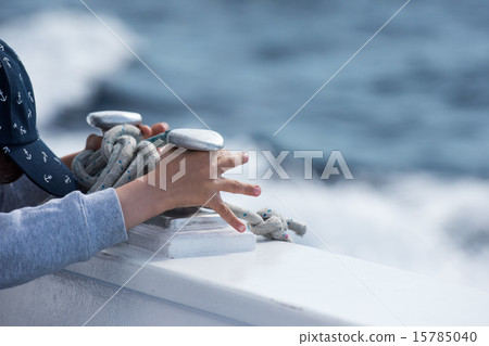 children hands while holding boat bollard 15785040