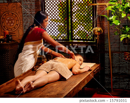 Woman having Ayurvedic spa treatment. Woman having Ayurvedic spa treatment. 15791031