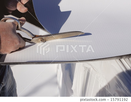 Construction site - cutting synthetic sheet PVC se 15791192