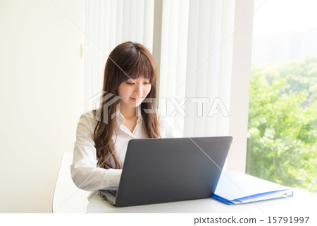 A young woman operating a PC A young woman operating a PC 15791997