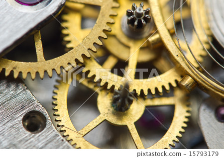 golden metal cogwheels inside clockwork. 15793179