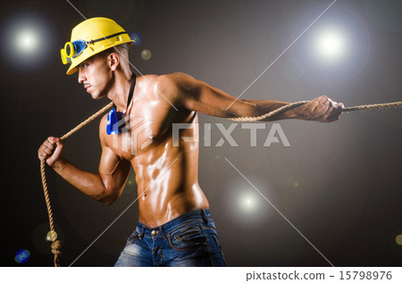 Nude builder pulling rope in darkness Nude builder pulling rope in darkness 15798976