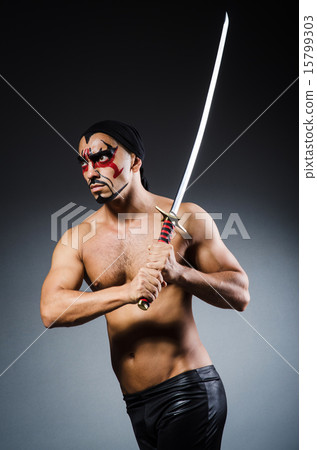 Man with sword and face paint Man with sword and face paint 15799303