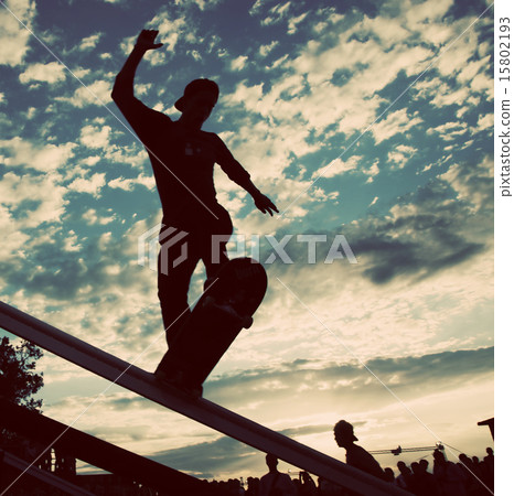 skateboarder silhouette doing a slide trick skateboarder silhouette doing a slide trick 15802193