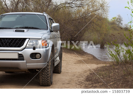 4x4 SUV on a road near a river 15803739