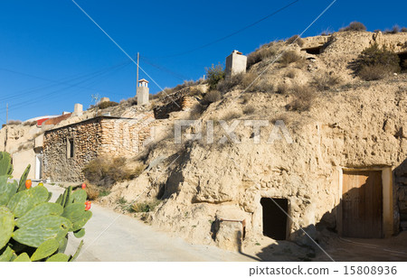 Street at village with dwelling  houses into rocks 15808936