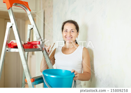 woman makes repairs at home 15809258