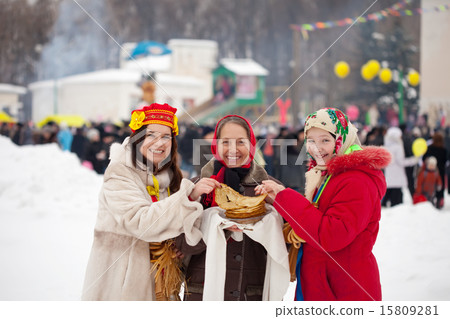 Women tasting pancake during Shrovetide Women tasting pancake during Shrovetide 15809281