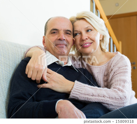 Couple pensioners together on sofa at home Couple pensioners together on sofa at home 15809318