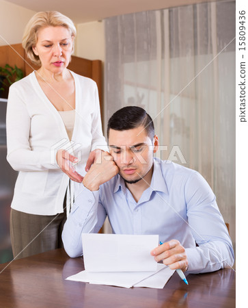 Adult son and senior mother with papers 15809436