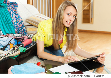 Young woman with tablet before leave 15809498