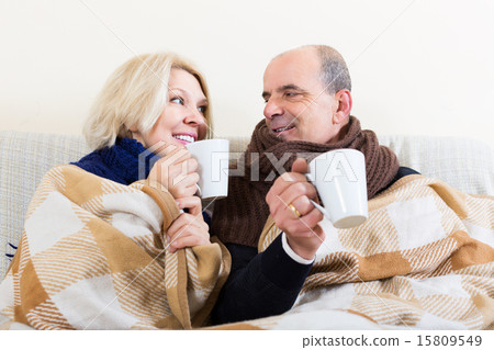 Couple warming up with tea 15809549