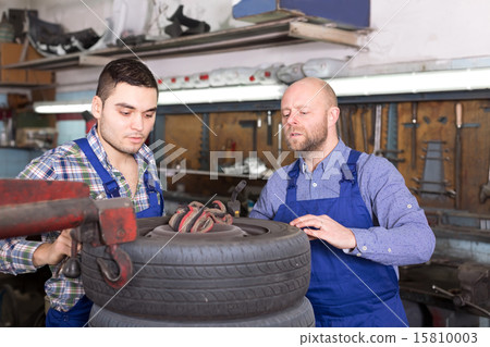 Mounting specialists in coveralls working 15810003