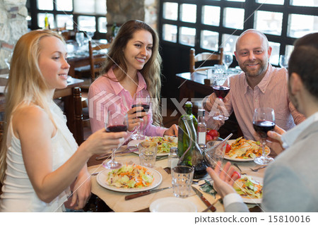 Young people enjoying food at tavern 15810016