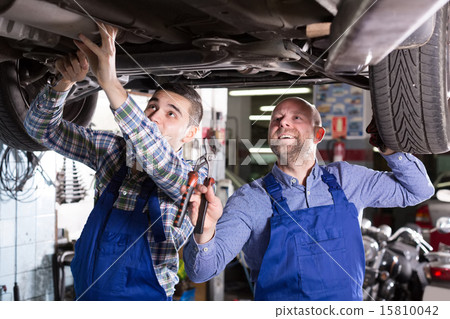 mechanics fixing car 15810042