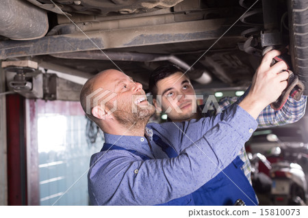 Two car mechanics at workshop Two car mechanics at workshop 15810073