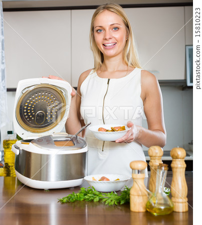 Woman cooking with multicooker 15810223