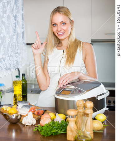 Woman cooking with multicooker 15810241