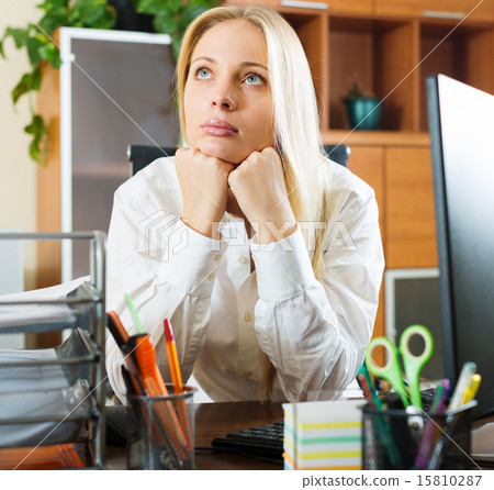 woman in white dreaming at office desk 15810287