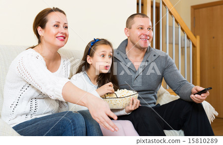 Family sitting with popcorn 15810289