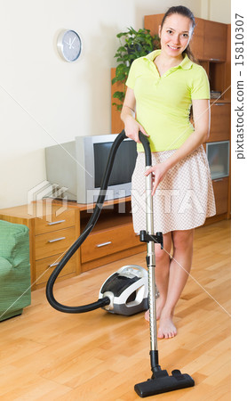 Woman cleaning with vacuum cleaner Woman cleaning with vacuum cleaner 15810307