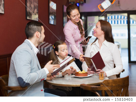 Waitress and family at cafe 15810403