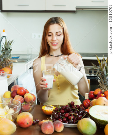 woman drinking milk cocktail with fruits woman drinking milk cocktail with fruits 15810703