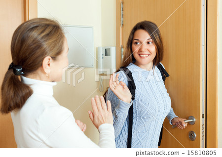 Mother sees off adult daughter at the door 15810805