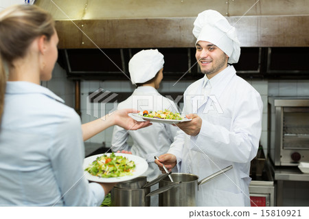 Waitress with plates at kitchen 15810921