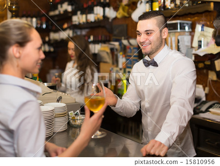 Positive female chatting with bartenders Positive female chatting with bartenders 15810956