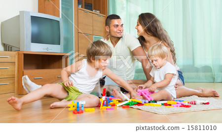 Happy family playing in home interior Happy family playing in home interior 15811010