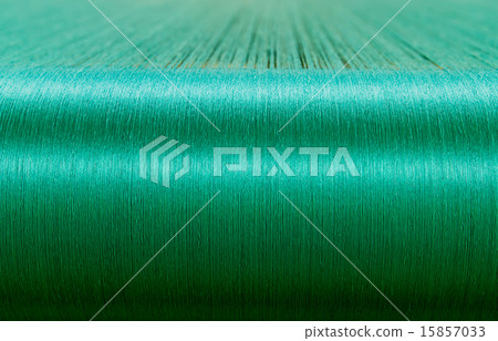 Green silk on a warping loom of a textile mill Green silk on a warping loom of a textile mill 15857033