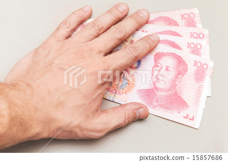 Chinese 100 yuan renminbi banknotes and male hand 15857686
