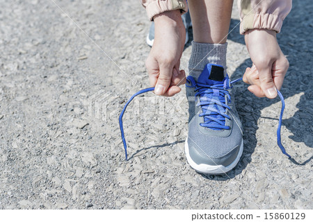 Women's hands connecting shoelaces 15860129