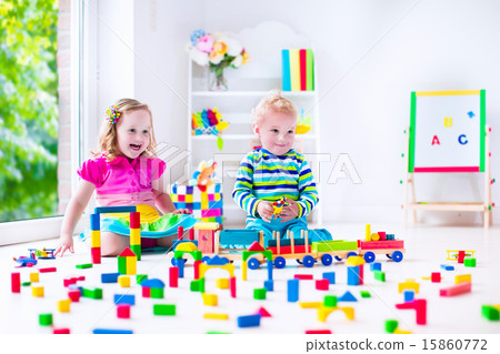 Kids playing at day care with wooden toys Kids playing at day care with wooden toys 15860772