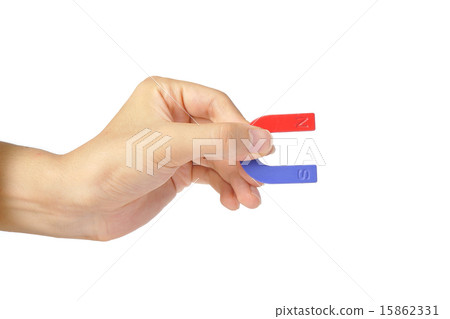 Human hand holding a magnet 15862331