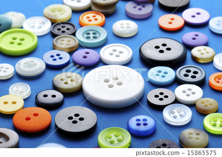 Many buttons on blue cloth 15865575