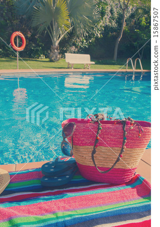 towel and bathing accessories near pool 15867507
