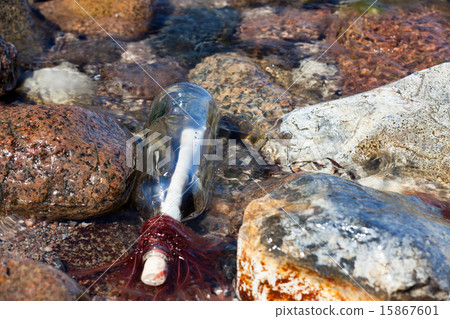Message in a bottle in the water 15867601