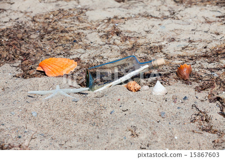 Message in a bottle on the beach with seashells Message in a bottle on the beach with seashells 15867603