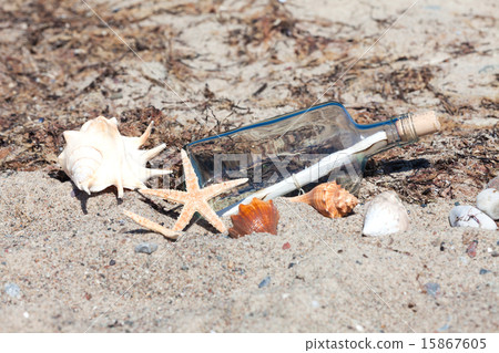 Message in a bottle on the beach with seashells Message in a bottle on the beach with seashells 15867605