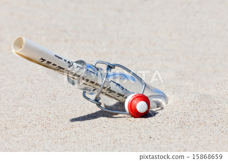 A message in a bottle is in the sand on the beach A message in a bottle is in the sand on the beach 15868659
