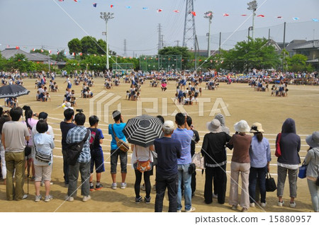 A family watching group gymnastics at an athletic meet 15880957