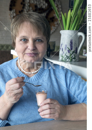 Old woman wearing a blue sweater sitting in the cafe Old woman wearing a blue sweater sitting in the cafe 15881653