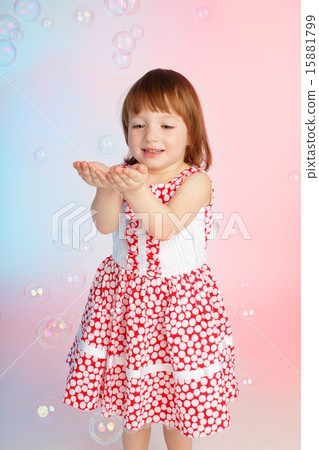 Child playing with soap bubbles Child playing with soap bubbles 15881799