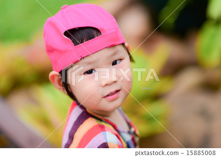Cute Asian girl wearing pink cap. 15885008