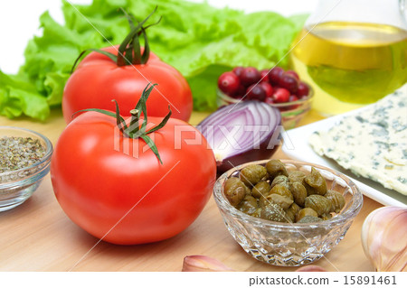 Ripe tomatoes and other foods on a cutting board 15891461
