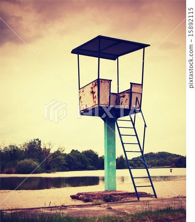 usty metal lifeguard tower with chair on a beach. 15892115