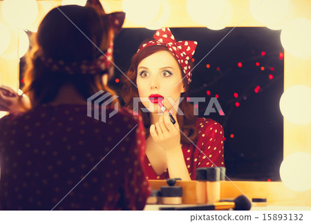 woman applying cosmetics 15893132